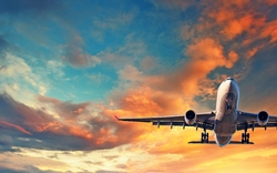 Flugzeug fliegt in den Sonnenuntergangshimmel.