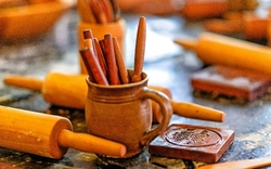 Backutensilien aus Holz auf einem Tisch, darunter Nudelholz und Buttermodel.
